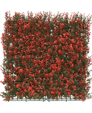 Die künstliche Hecke Buchsbaum rot 50x50 cm UV ist eine quadratische künstliche grüne Platte mit dichten kleinen grünen Blättern und roten Blütenbüscheln, ideal als Dekoration oder Sichtschutz.